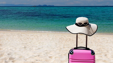The Banner of travel in Summer tropical concept with Pink luggage on the white sand Beach background