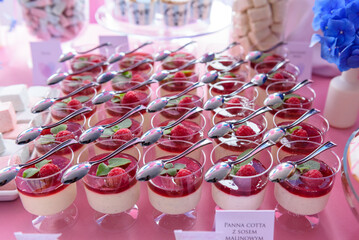 Delicious panna cotta desserts on a candy bar at a wedding party