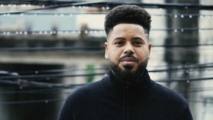 A young diverse man standing in urban street portrait face