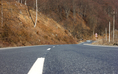 Winding road through mountains and forest, hilly road with markings beautiful nature of the Carpathian mountains of Ukraine