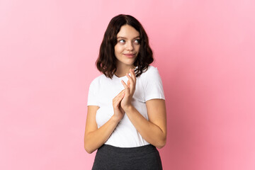Teenager Ukrainian girl isolated on pink background scheming something