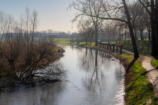 Gravel walkway along Niers river with sunlight, The river is in Germany and Holland a right tributary of the river Maas, Gennep is a municipality and a city in upper southeastern Netherlands, Nijmegen