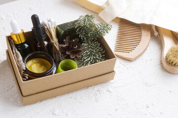 Eco cosmetic products for skin care of the face, body in a natural paper box. Glass cosmetic bottles with essential oil, creamy, soap with minerals, vitamins, prebiotics.