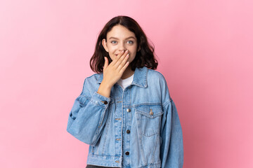 Teenager Ukrainian girl isolated on pink background happy and smiling covering mouth with hand