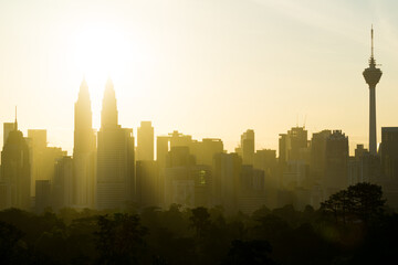 Majestic sunrise over downtown Kuala Lumpur with Petronas Twin Towers and KL Tower still among the...