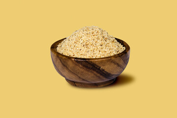 Chopped walnuts in wooden bowl on light background including clipping path