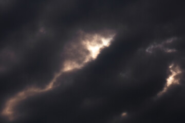 Fototapeta na wymiar Dark storm clouds covering the sun