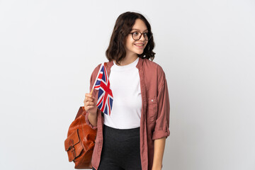 Teenager Ukrainian girl holding an United Kingdom flag looking side