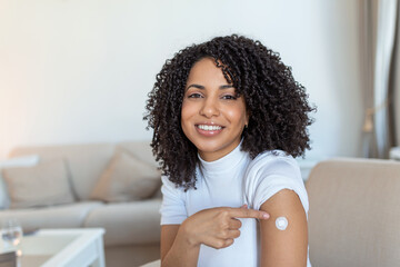 Covid-19 Vaccination. Portrait Of Happy Vaccinated African woman Showing Her Arm After Coronavirus...