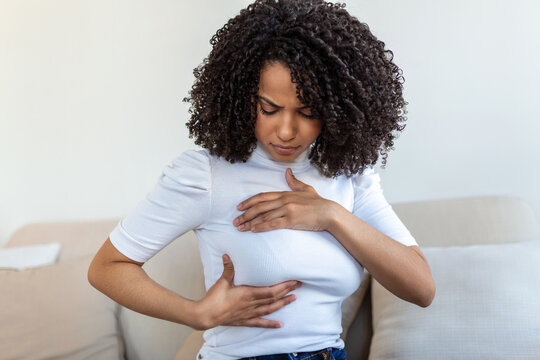 Young African American Woman Palpating Her Breast By Herself That She Concern About Breast Cancer. Healthcare And Breast Cancer Concept