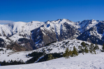 Fototapeta na wymiar France, Ariege, Mountains Pyrenees, winter sports scene, skiers on the slopes, High quality 4k footage
