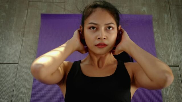 top view, beautiful Asian woman taking care of her health by exercising, sitting up intently, health concept , workout , social distancing
