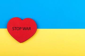 Flag of Ukraine with red heart and inscriptions Stop War.