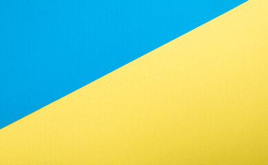 Top view on blue and yellow color Ukrainian flag paper background