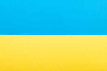 Top view on blue and yellow color Ukrainian flag paper background