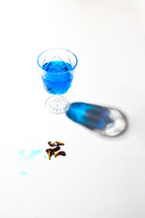 Cold blue tea on white background with beautiful shadow .