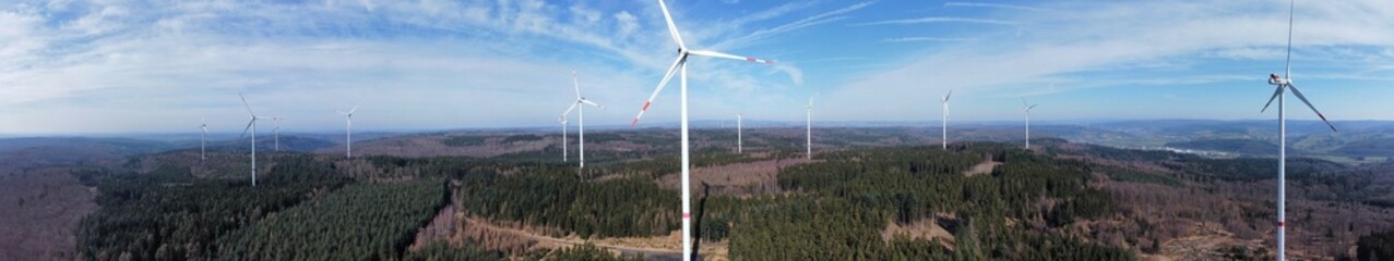 Fototapeta na wymiar Green electricity future Panoramic view of wind turbines