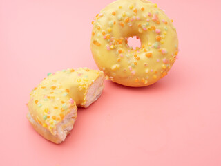 Fresh lemon donut on a pink background. lemon donut