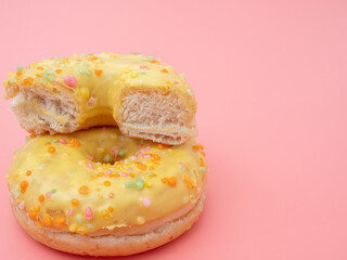 Fresh lemon donut on a pink background. lemon donut
