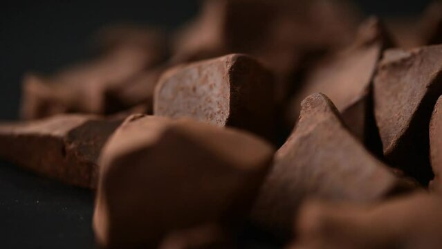 chocolate rotate,dark chocolate on black,cacao piece
