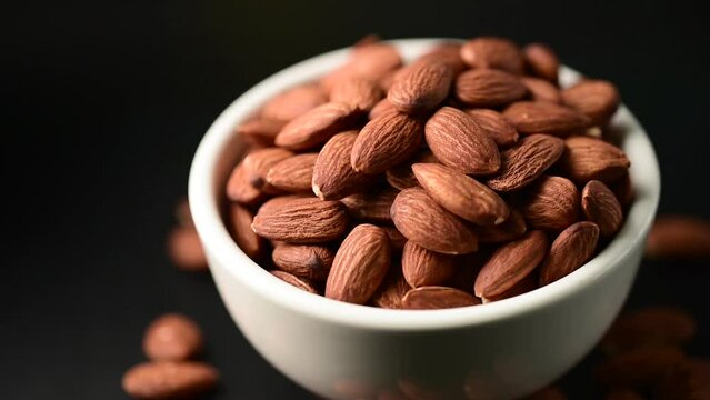 almonds in blow rotate,close up bean almond black isolated rotate