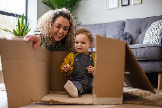 Mother and Toddler playing with a cardboard box