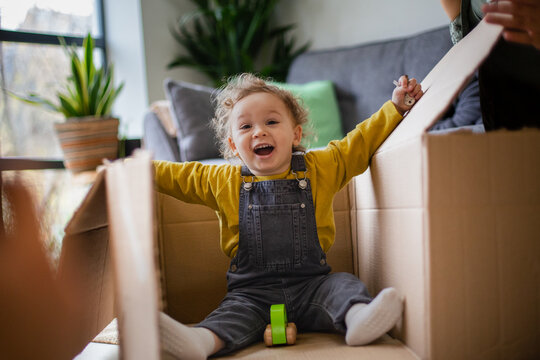 Mother and Toddler playing with a cardboard box