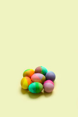 Fototapeta na wymiar Pastel Easter eggs in nest on a sunny yellow background. Minimal creative concept of Easter.