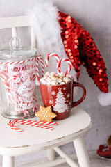 Gingerbread with mug of hot chocolate and candy cane.