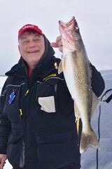 Ice angler with a walleye 