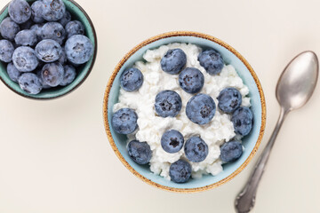 Cottage cheese with blueberry, fresh berries, keto healthy breakfast concept, top view.