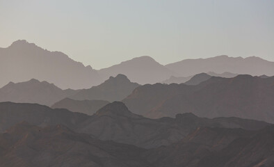 Dramatic layered mountains of Sinai in the evening. View from Dahab. South Sinai, Egypt