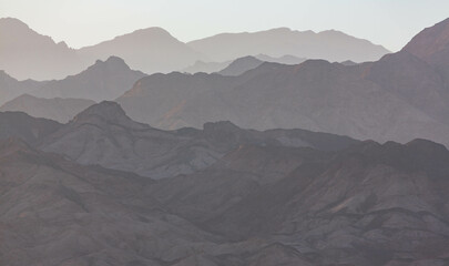 Dramatic layered mountains of Sinai in the evening. View from Dahab. South Sinai, Egypt