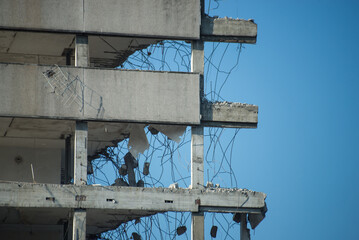 Closeup of demolished building on blue sky background