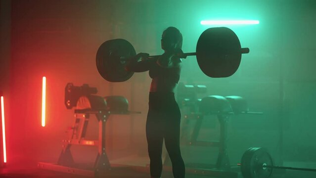 powerful woman is lifting barbell in gym, powerlifting and bodybuilding training for keeping fit