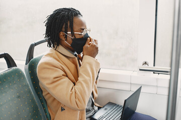 Young African businessman sitting in a bus