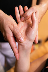 close up of a person receiving a hands massage 