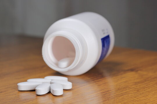 Anti-Radiation Pills, Iodine Tablets, Tablets For Radiation Protection On The Wooden Table With A White Medical Jar 