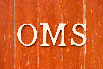 Alphabet letter in word OMS (Abbreviation of Order management system or Operations management system) on old red color wood plate background