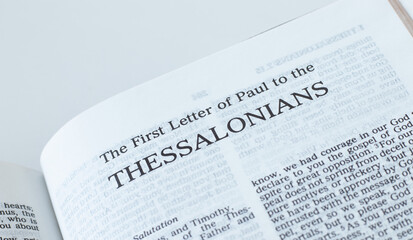Thessalonians open Holy Bible Book close-up. New Testament Scripture. Studying the Word of God Jesus Christ. Christian biblical concept of faith and trust.