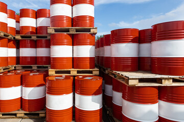 Red-white barrels with oil. Warehousing containers ready for shipment. Refining and selling oil...