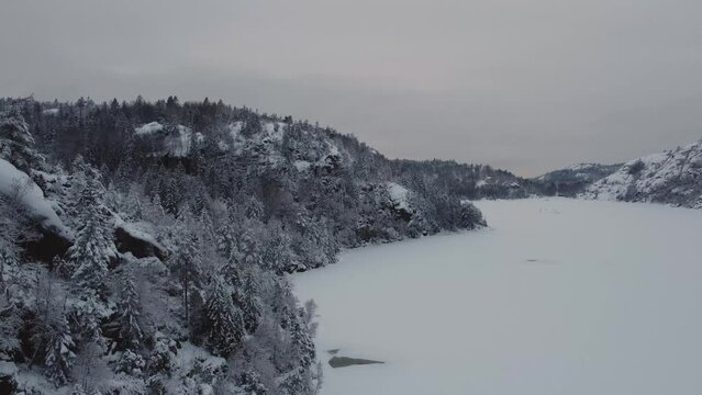 Descending on Lake Dingle Dam Snow Covered Trees Sweden Mountain 4K 30fps