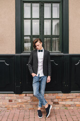 Attractive young man on the street on a background of pencil background.