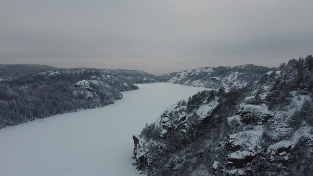 Descending Nearing Lake Dingle Dam Snow Covered Mountain Trees Sweden 4K 30fps