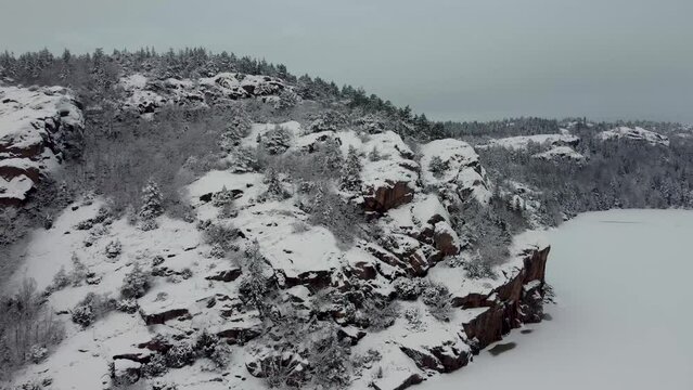 Flying away from Snow Covered Mountain Lake Dingle Trees Sweden 4K 30fps