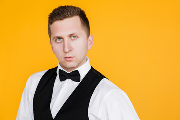 Portrait of an attractive 25 year man, future generation, businessman on yellow background in Ukraine.