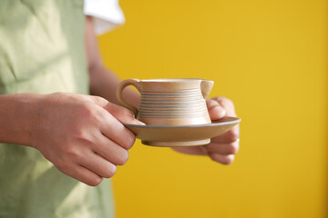 hand holding cup of green tea with copy space 