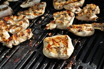 Cooking chicken on the grill for a backyard barbecue