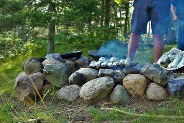 Cooking corn on the cob over a camp fire