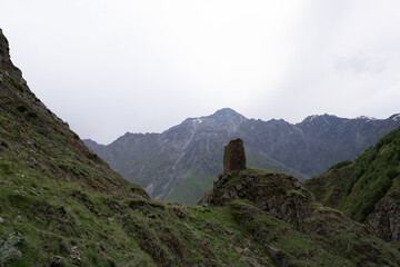 The mountain ranges of Georgia, Kazbegi, where two mountains form a triangular shape and above them a mountain spice that is covered with white snow